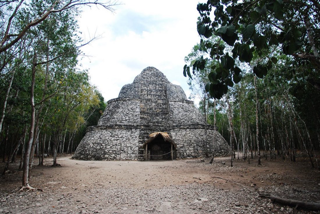 Round stepped Mayan pyramid in a jungle clearing