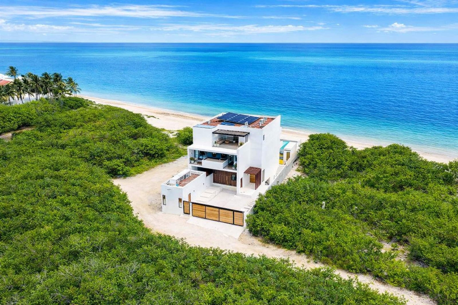 Aerial view of the villa on the beach at Petempich Bay, between the turquoise sea and the jungle