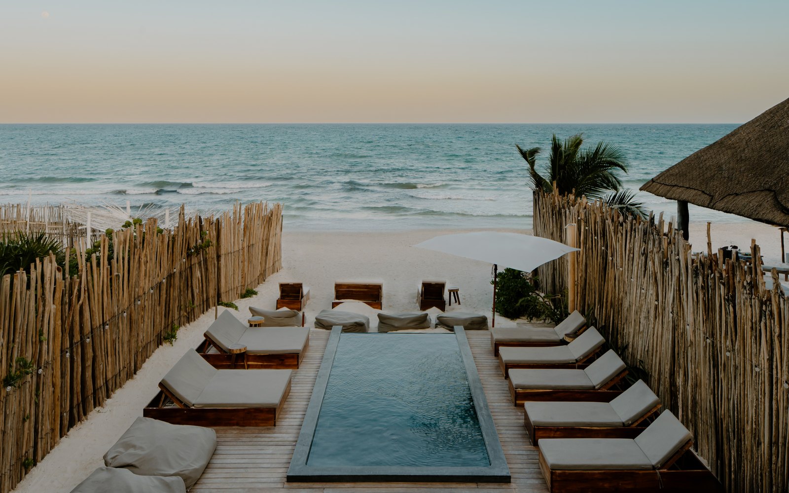 The pool with sun loungers facing the sea